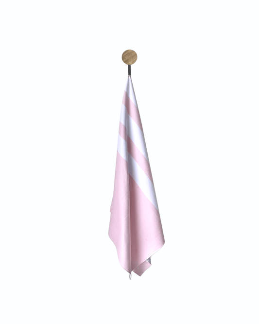 Pink and white striped towel hanging on a wooden hook against a white background